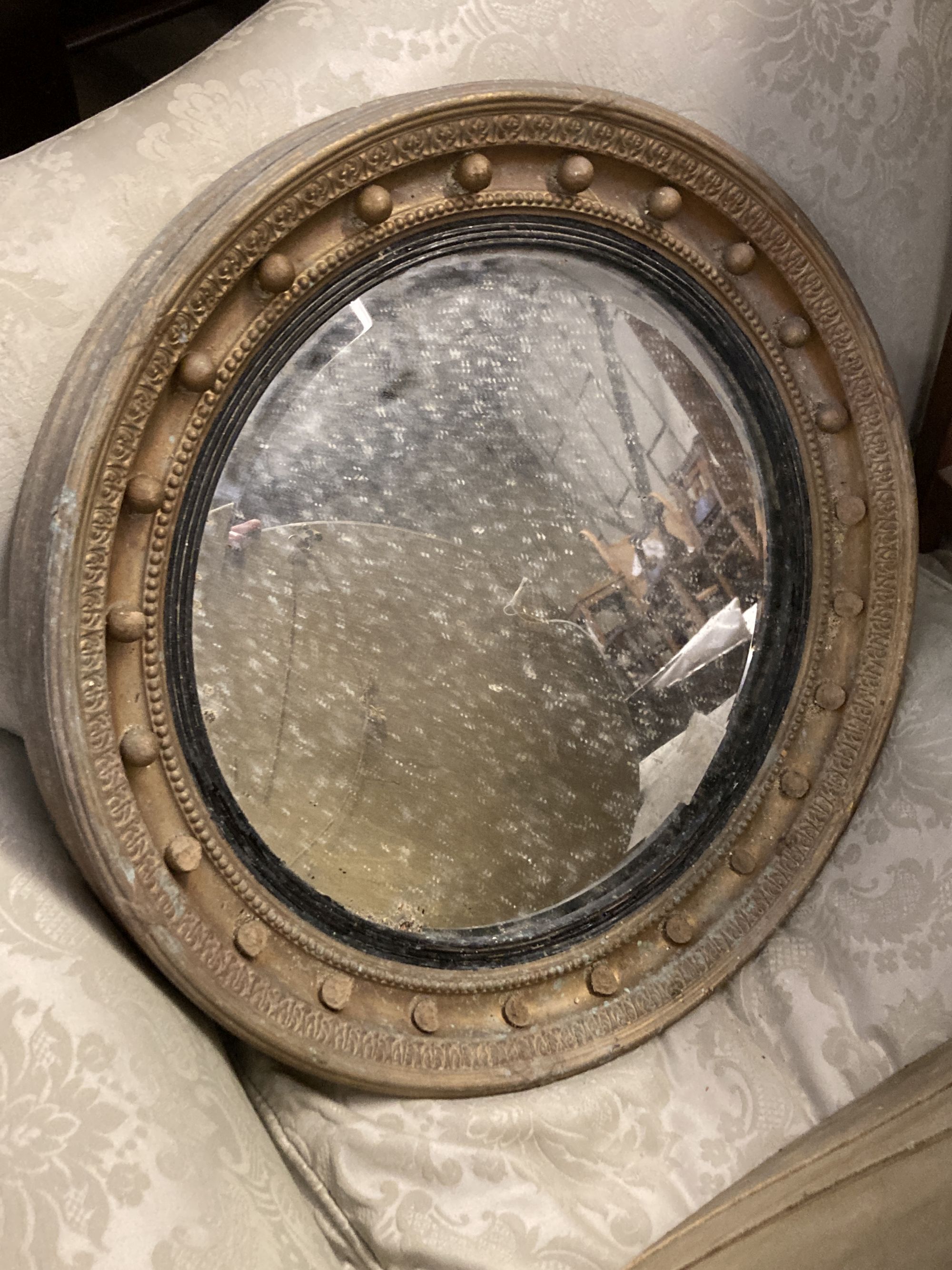 Four circular gilt framed convex and wall mirrors, largest 50cm diameter